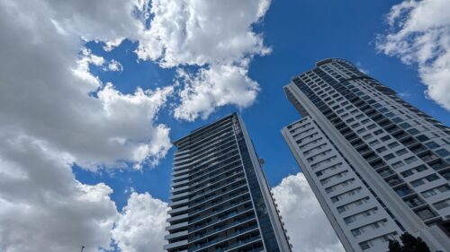 City high rise with blue sky & clouds