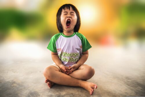 Seated child yawning